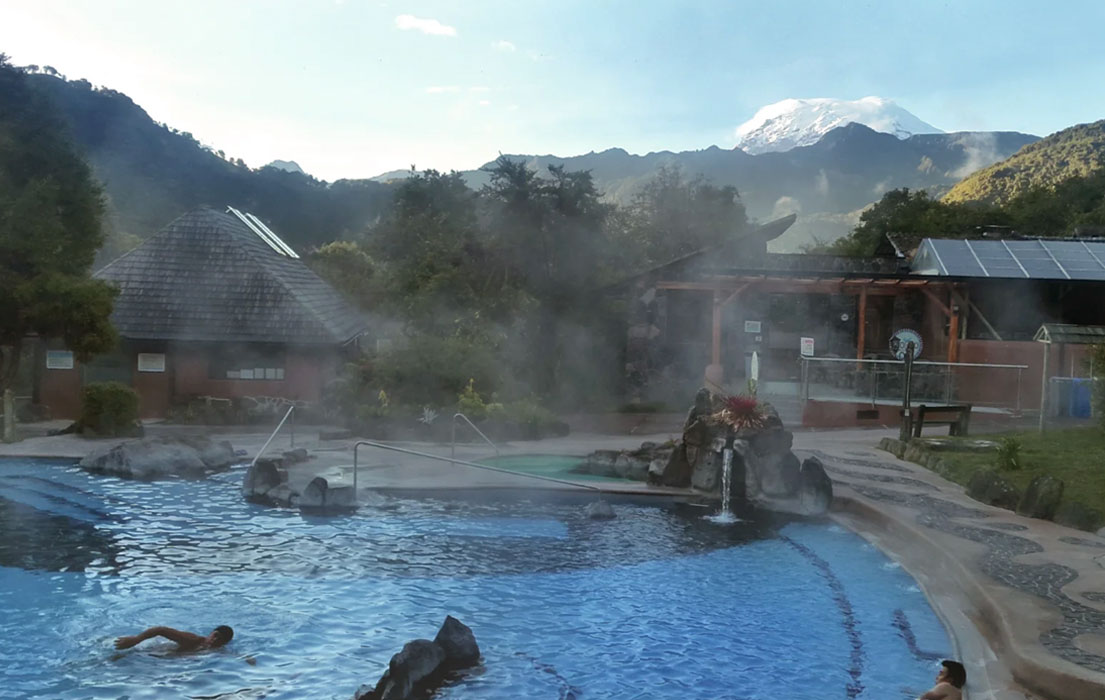 A man swimming in a hot springs pool