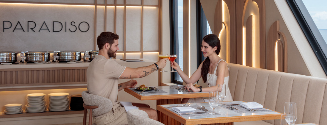 Man-and-woman-with-drinks-having-dinner-onboard Man and woman with drinks having dinner onboard