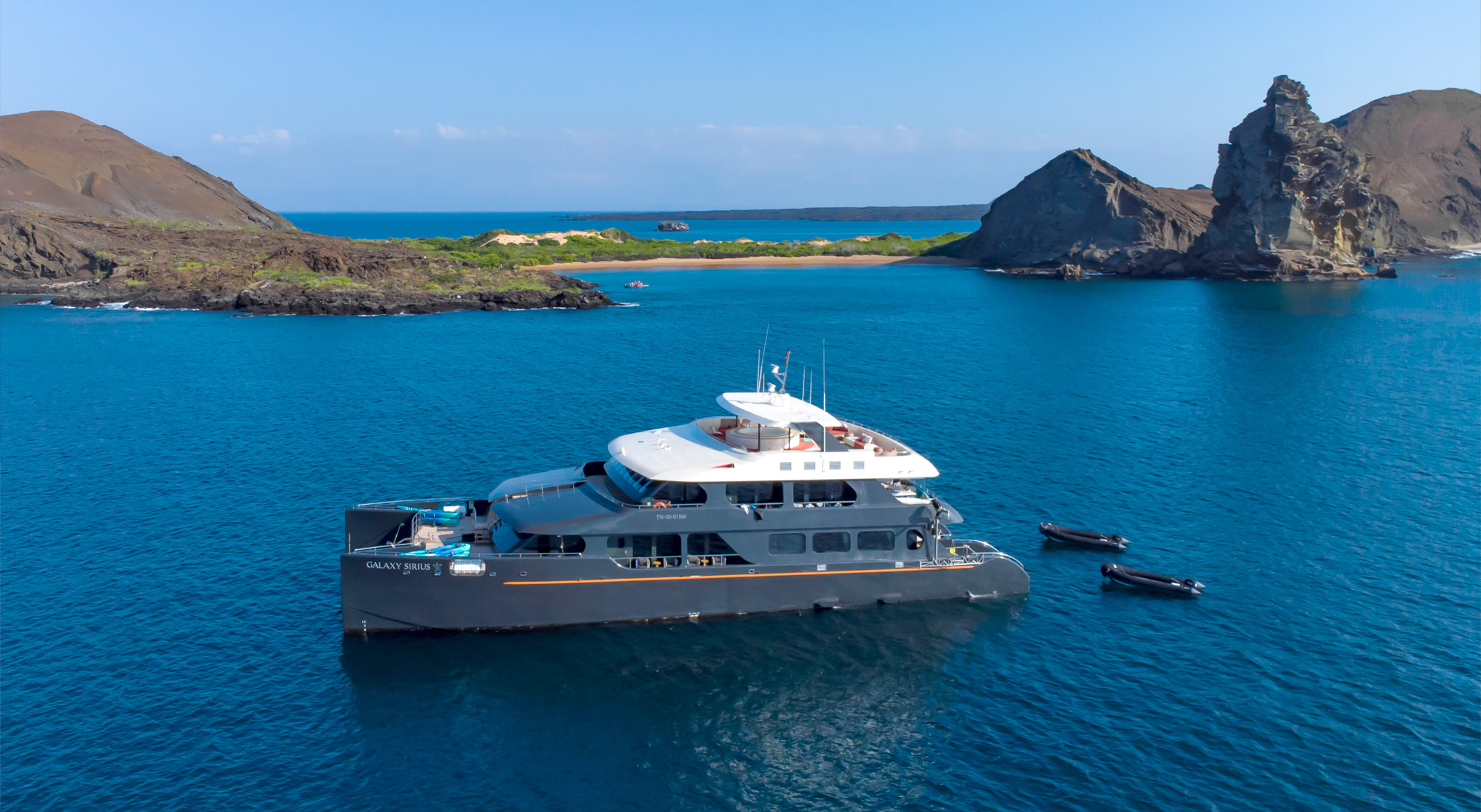 Galaxy-Sirius-in-Galapagos-Bay Choosing a Galápagos charter yacht, a premium vessel at anchor in a quiet bay.